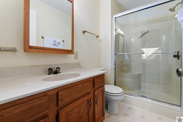 bathroom featuring vanity, toilet, and walk in shower