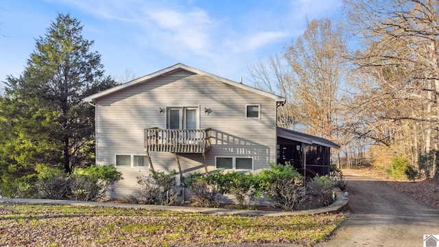 rear view of property with a balcony