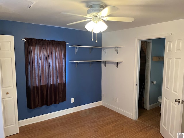 unfurnished bedroom with hardwood / wood-style floors, ceiling fan, and a closet