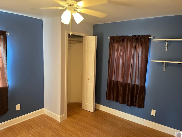 unfurnished bedroom featuring ceiling fan, a closet, and light hardwood / wood-style floors