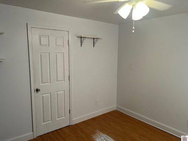 empty room with ceiling fan and wood-type flooring