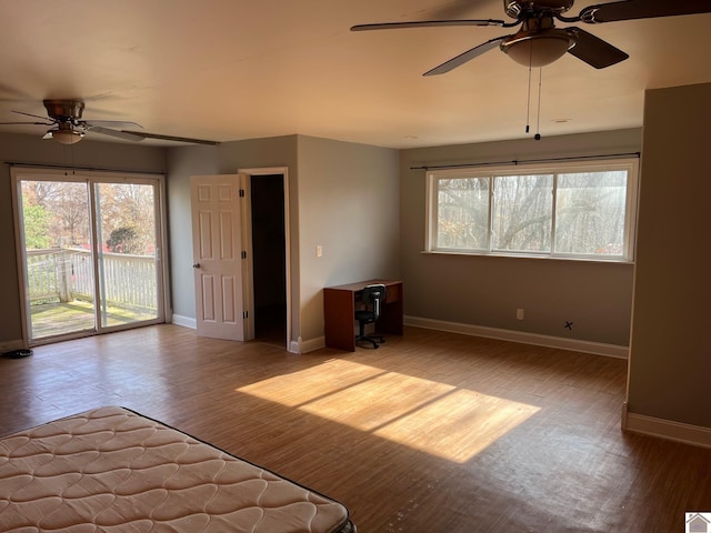 unfurnished bedroom featuring ceiling fan, light hardwood / wood-style floors, and access to exterior