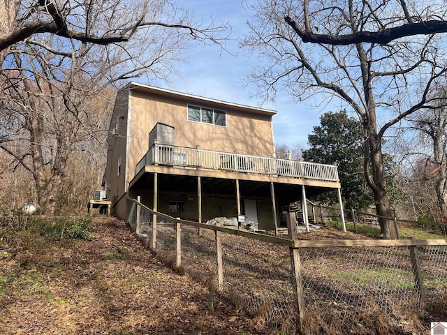 rear view of house with a wooden deck