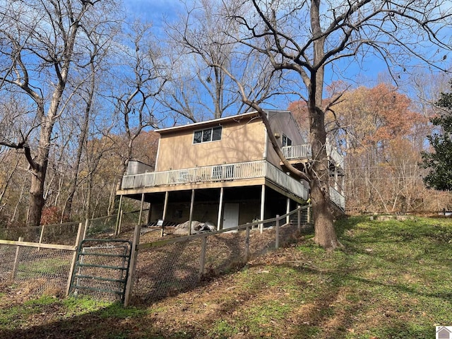 rear view of property featuring a wooden deck