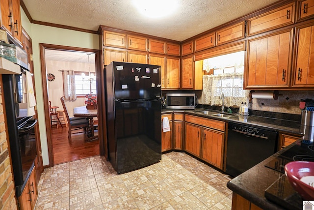 kitchen featuring black appliances, crown molding, sink, decorative backsplash, and a textured ceiling