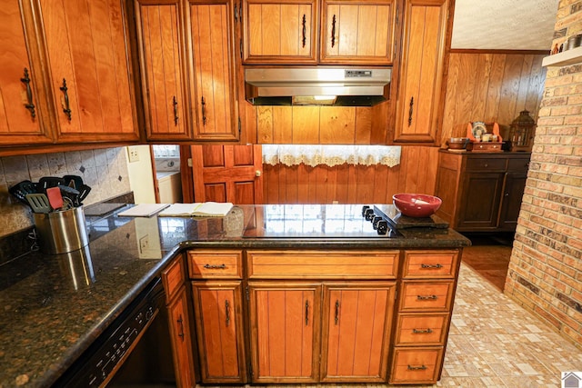 kitchen with dishwasher, dark stone counters, brick wall, and gas cooktop