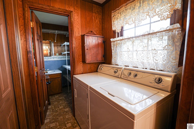 washroom featuring wood walls and separate washer and dryer