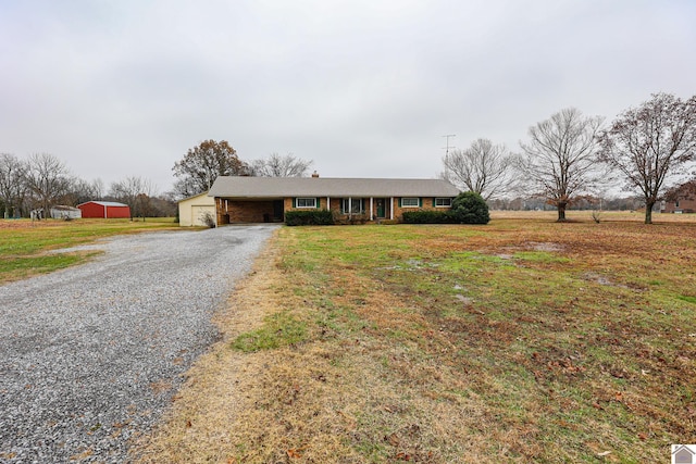 ranch-style house featuring a garage and a front lawn