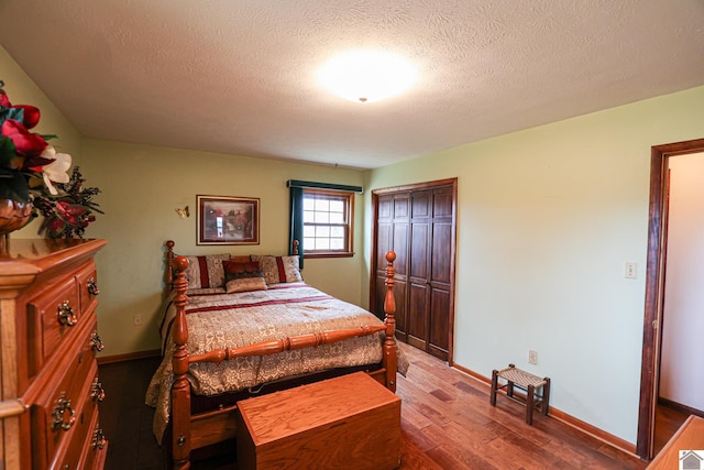 bedroom featuring hardwood / wood-style floors and a textured ceiling