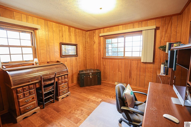 home office featuring hardwood / wood-style floors, wood walls, and a textured ceiling