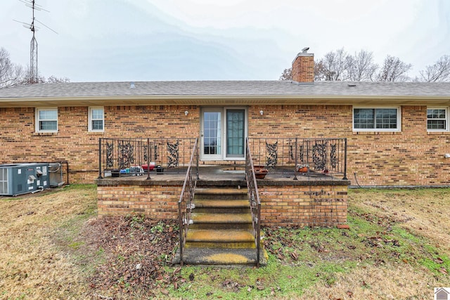 rear view of property featuring central AC