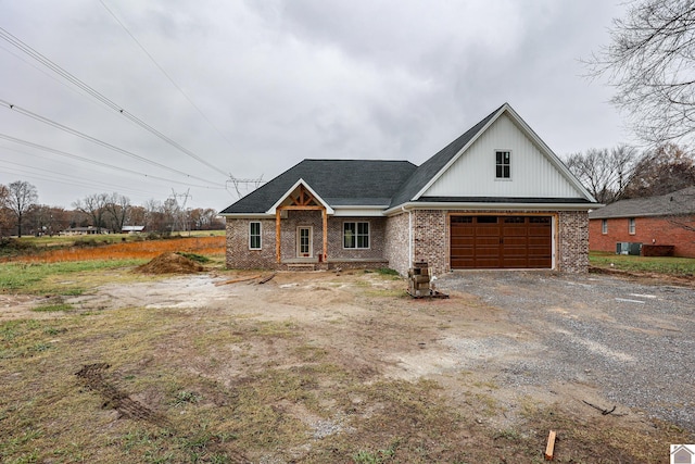 view of front of home featuring cooling unit and a garage