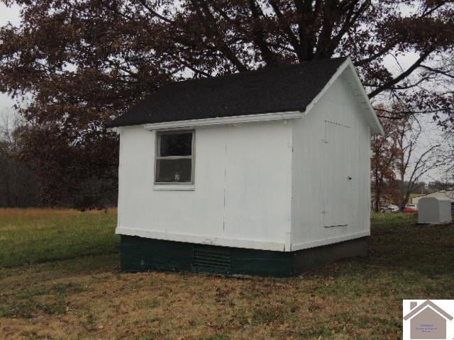 view of outbuilding featuring a lawn