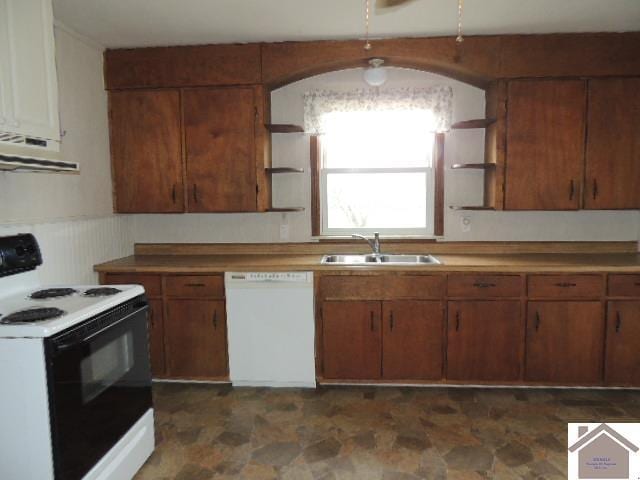 kitchen with white appliances, ventilation hood, and sink