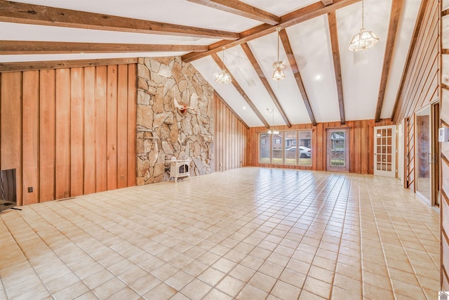 interior space featuring high vaulted ceiling, beam ceiling, wooden walls, and a chandelier