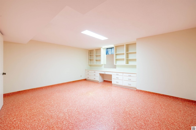 unfurnished office featuring carpet and built in desk