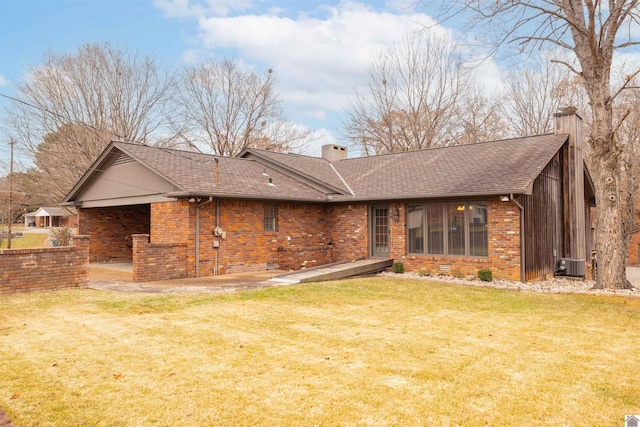 rear view of house with a lawn and cooling unit