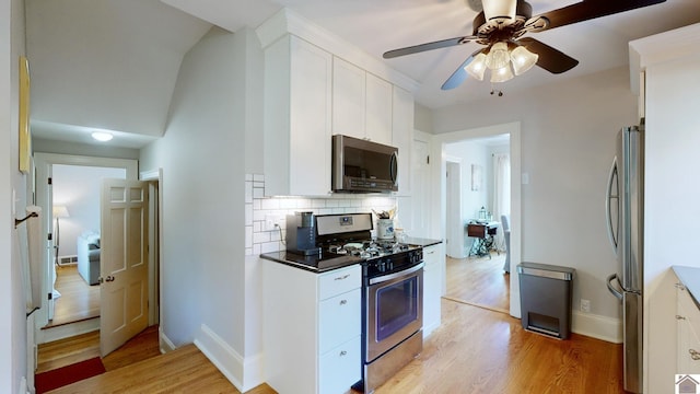 kitchen featuring white cabinetry, stainless steel appliances, and light hardwood / wood-style floors