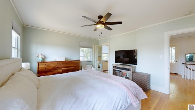 bedroom featuring multiple windows, light hardwood / wood-style flooring, ceiling fan, and crown molding