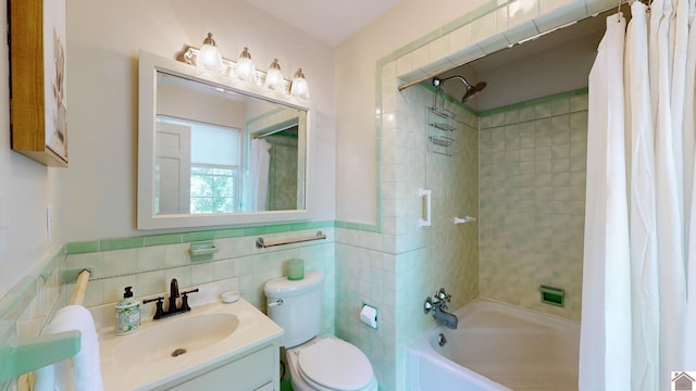 full bathroom with shower / bath combination with curtain, vanity, toilet, and tile walls