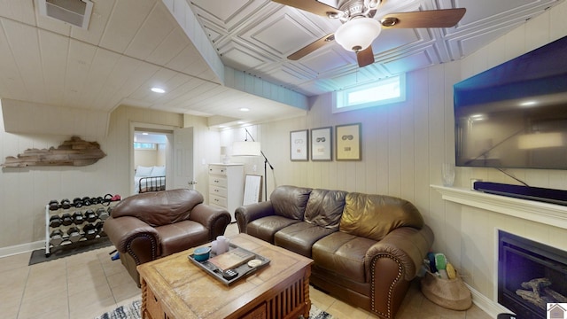 tiled living room featuring ceiling fan