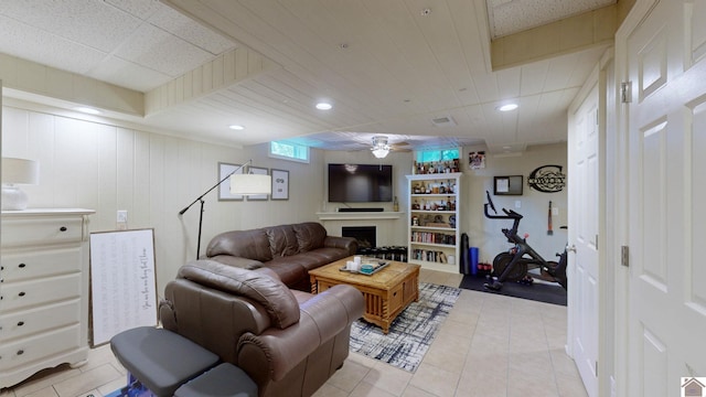 tiled living room with ceiling fan