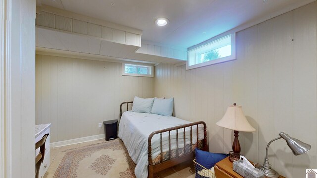 bedroom featuring wood walls