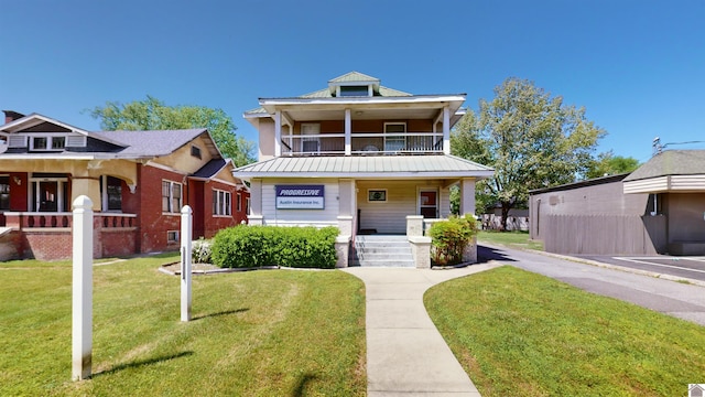 view of front of house featuring a balcony, a front lawn, and a porch