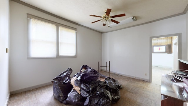 miscellaneous room featuring ceiling fan, light parquet flooring, a textured ceiling, and ornamental molding