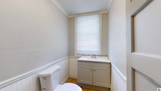 bathroom featuring crown molding, vanity, and toilet