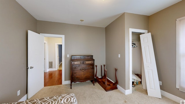 bedroom featuring light carpet and a closet