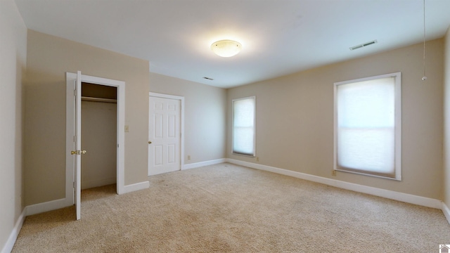 unfurnished bedroom featuring light carpet