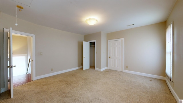 unfurnished bedroom featuring light colored carpet