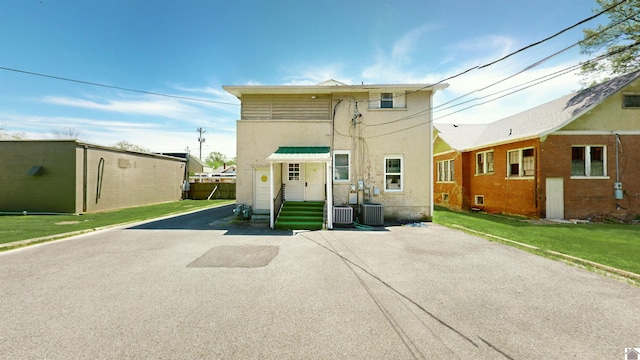 exterior space with a front lawn and cooling unit