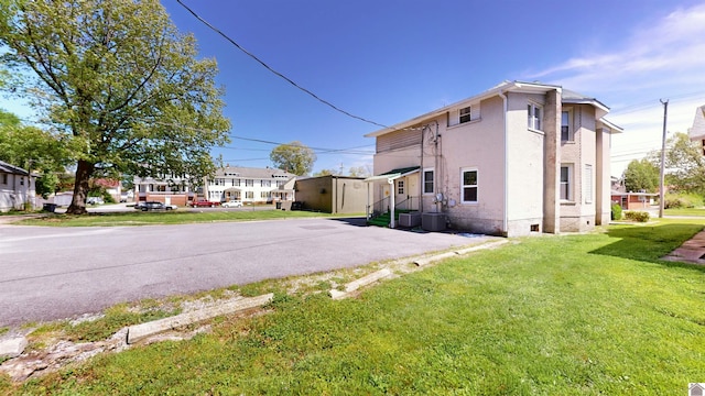 view of property exterior with a lawn