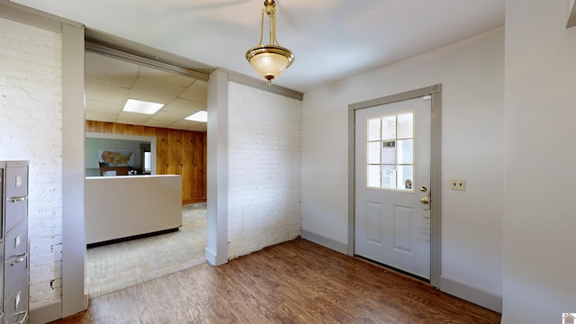 doorway featuring wood walls and hardwood / wood-style floors