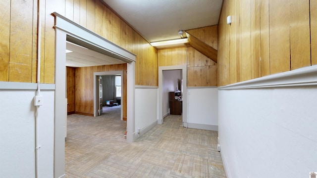 hall featuring wooden walls