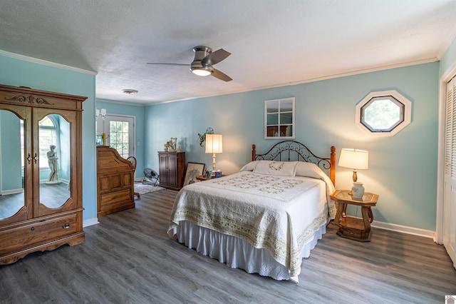 bedroom featuring ceiling fan, french doors, dark hardwood / wood-style flooring, crown molding, and a closet