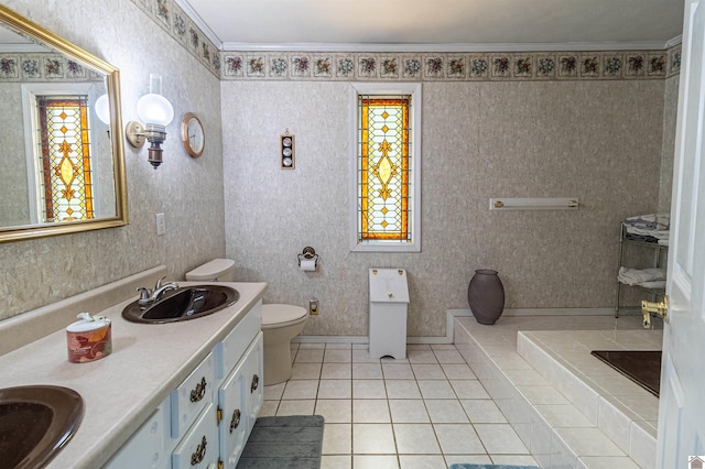 bathroom featuring tile patterned floors, vanity, toilet, and crown molding