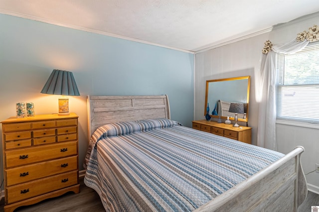 bedroom featuring ornamental molding and dark wood-type flooring