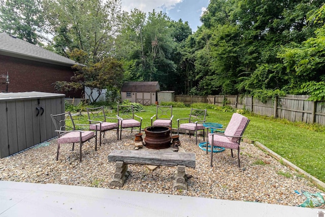 view of yard with a fire pit and a storage shed