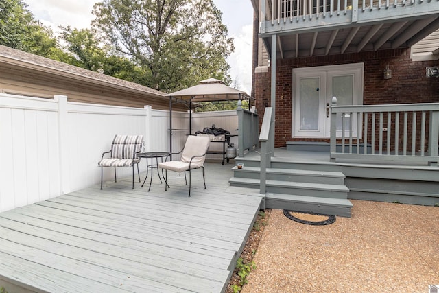 wooden terrace featuring a gazebo