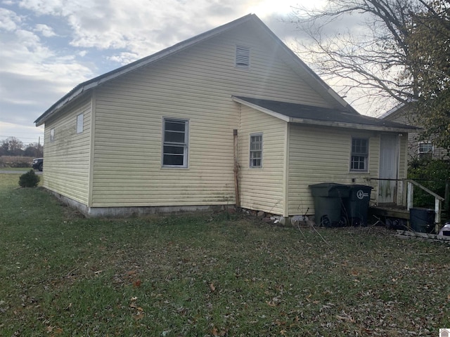 rear view of house with a yard