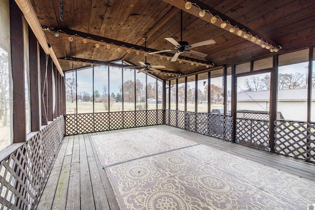 unfurnished sunroom featuring a wealth of natural light, wooden ceiling, and lofted ceiling with beams