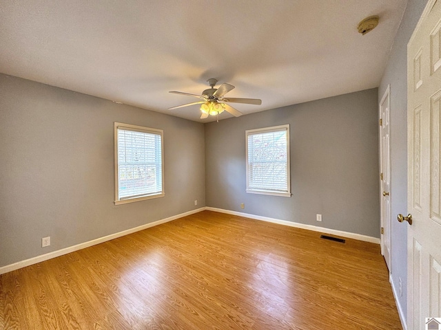 unfurnished room featuring ceiling fan and hardwood / wood-style flooring