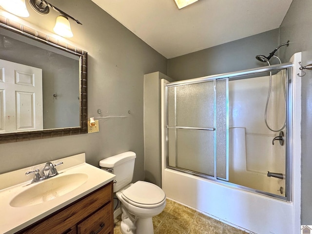 full bathroom with shower / bath combination with glass door, vanity, and toilet