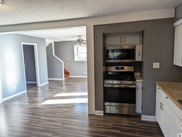 kitchen featuring appliances with stainless steel finishes, dark hardwood / wood-style flooring, a textured ceiling, ceiling fan, and white cabinetry