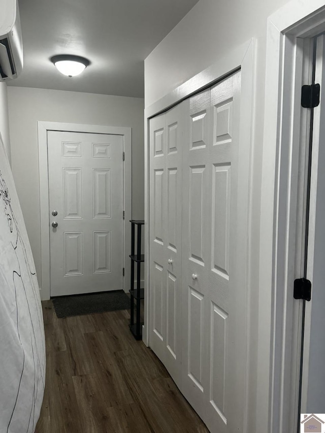 doorway to outside featuring a wall mounted air conditioner and dark hardwood / wood-style flooring