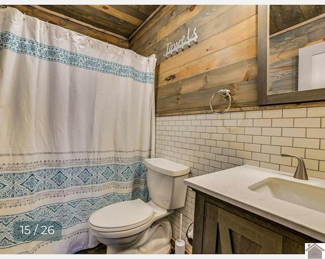 bathroom featuring wooden walls, vanity, tile walls, and toilet