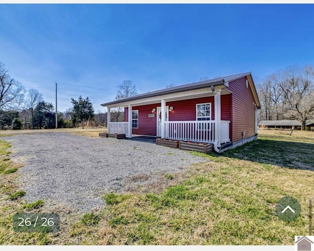 view of front of property with covered porch and a front lawn